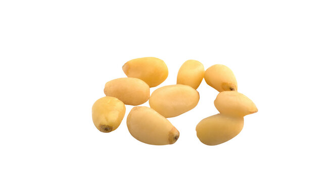 Fresh peeled pine nuts isolated on black background