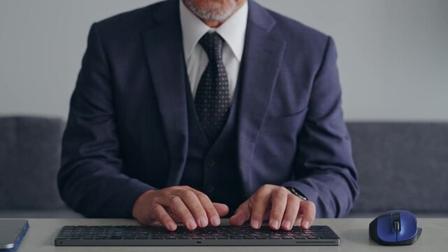A male business person operating a PC keyboard. Typing, engineer, programmer, systems, development.