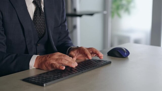 A male business person operating a PC keyboard. Typing, data entry, programming, systems, engineer.