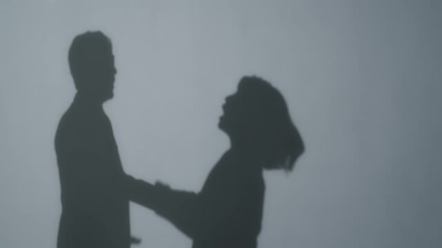 Silhouette of a couple arguing