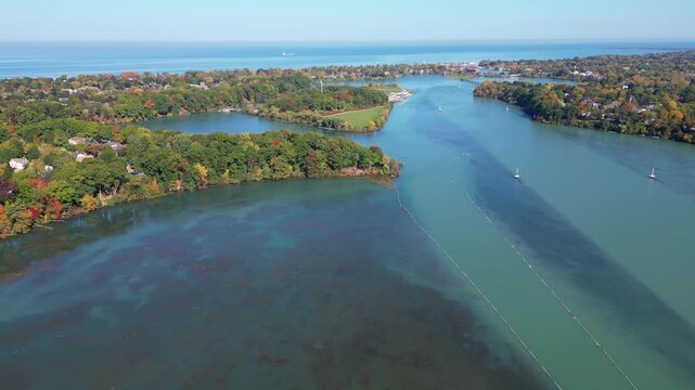 Aerial moving forward over Martindale Pond towards Henley Island, Port Dalhousie and Lake Ontario in St. Catharines, Ontario, Canada on a sunny Autumn day in October, 2024.