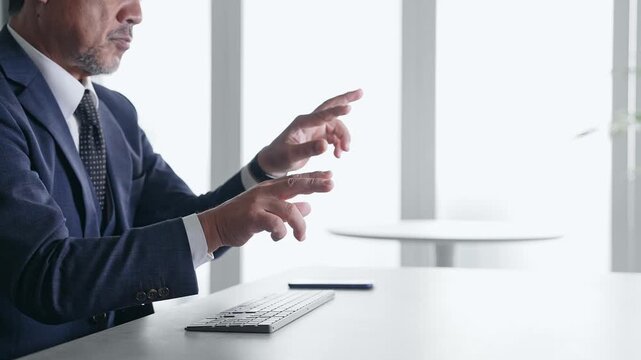 A male businessperson operating a screen in mid-air. VR, virtual, hologram, operation, stereoscopic image, office
