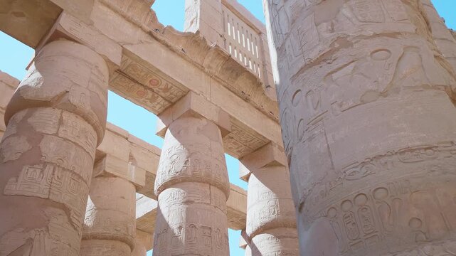 Footage capturing the grandeur of the ancient Egyptian Karnak Temple Complex in Luxor, Egypt. Features intricately carved columns adorned with hieroglyphs, showcasing the architectural marvels and ric