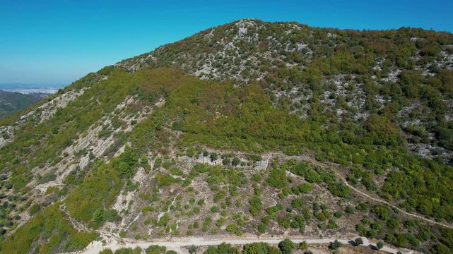 Panoramic drone footage of ancient Illyrian Persqopi Castle ruins on a rocky hilltop