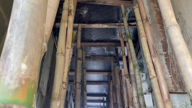 Bamboo Poles Supporting Concrete Formwork During Building Construction