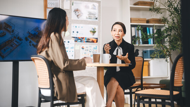 Leader business mature woman asian working together traning team skill positive emotion at modern office