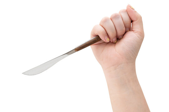 Female hand holding a steel cooking knife isolated on white background with a clipping path.