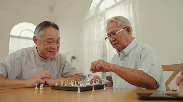 Caregiver senior chess man at home table enjoying indoor board game leisure with calm focus supportive companionship gentle strategy play bright room mental activity