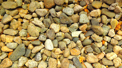 Abstract pattern of multi colored small boulders and pebbles on the ground  © fathurrachman
