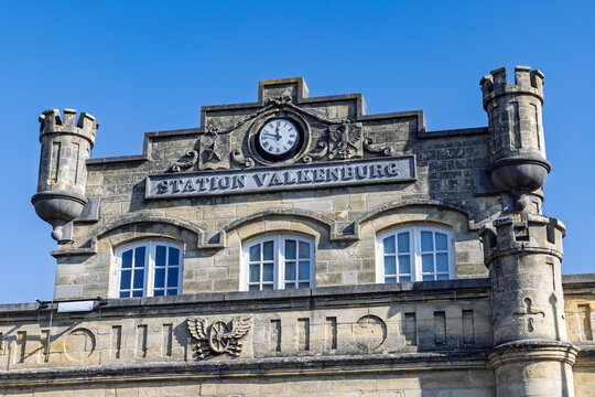 Valkenburg, Netherlands - October 04, 2026: Detail view of the historic marlstone station building facade featuring a clock, towers, and Dutch text.