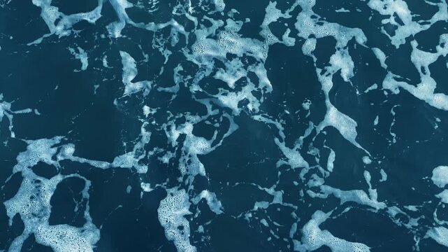 Blue ripples cross the sea surface in a minimal close view, offering background footage for marine presentations, environmental reports and water resource communications for public agencies