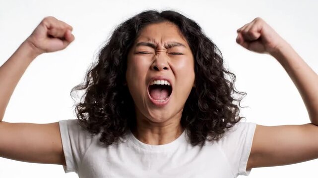 Static shot of woman shouting with raised fists in white studio portrait close up frontal expressive performance