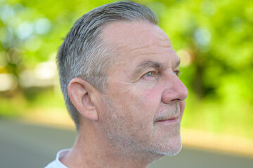 Mature businessman profile portrait outdoors confident © michaelheim