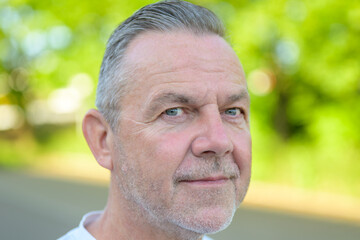 Confident mature man profile portrait outdoors © michaelheim