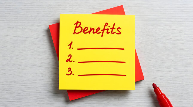 Two square sticky notes layered centrally on a light wood tabletop with a red marker in the corner showing the word Benefits handwritten above numbered lines one two and three for business planning