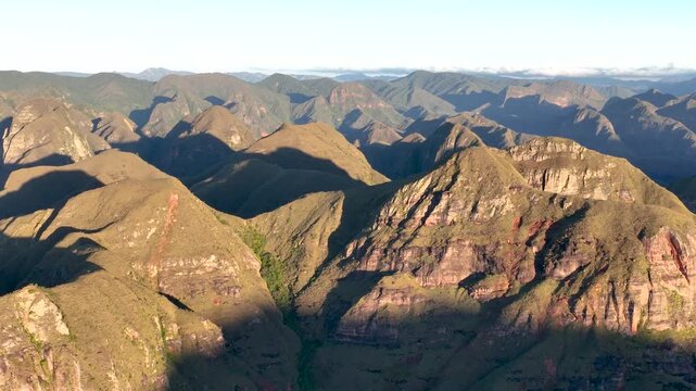 Codo de los Andes Mountain Ridges and Deep Valleys in Warm Golden Light in Bolivia. Establishing Shot. Aerial View.