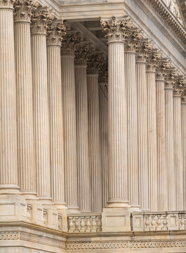 Columns architectural heritage stone facade. Columns marble symmetry repetition. Columns decorative capitals ornament Sculpture. Columns neoclassical design.