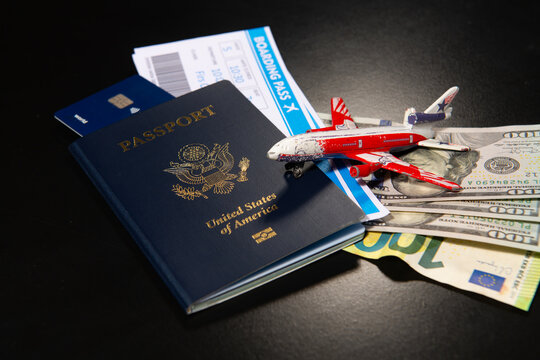 US passport with boarding pass credit card and toy airplane. International travel concept with American passport. Travel air flight concept. Travel budget. Airport trip preparation. Aviation travel.