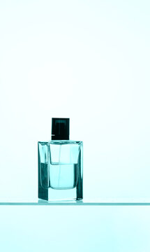 Sophisticated male fragrance display with a focus on bottle design. The blue-colored liquid and classic silhouette create a timeless look for men's cosmetic and fragrance collections.