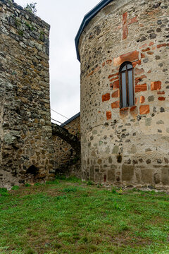 The church's backyard. An oval stone wall with a narrow window and a tower wall. Dmanisi Sioni cathedral, historic site. Georgia