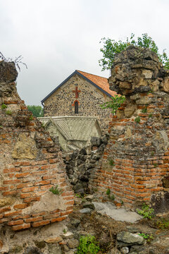 Medieval brick and stone walls held together with mortar. Church wall with a narrow window. Dmanisi Sioni cathedral, historic site, fortress. Georgia