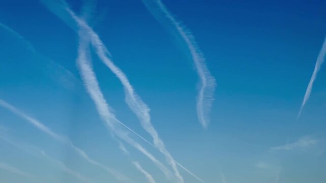 Blue sky with airplane trails