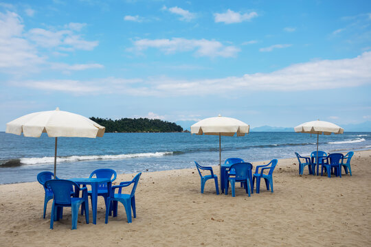 Beach village tables and chairs with umbrellas near the sea Brazil