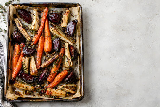 Roasted root vegetables on a parchment lined tray