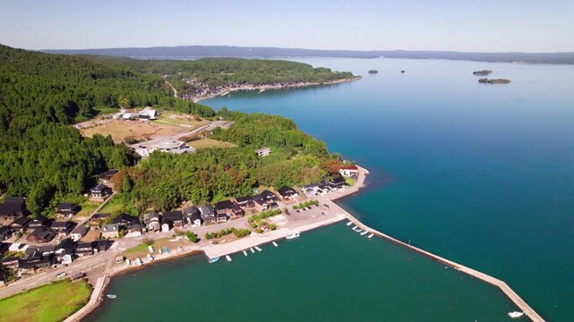 石川県能登島向田漁港と美しい海を後退しながら空撮（プルバック）/ Aerial pull back shot of Koda Port, Ishikawa.