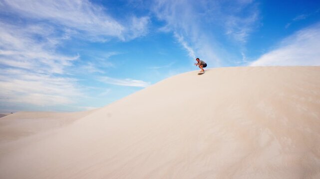 A man surfing a sand dune, Lancelin Dunes, Australia