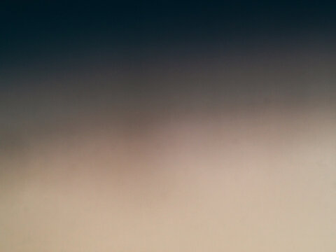 Dark navy to warm beige gradient dusk sky with fine grain, minimal abstract background, quiet twilight with soft blurred horizon