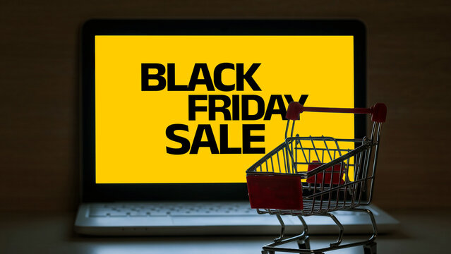 Black Friday sale displayed on a computer screen with a shopping cart next to it in a retail or online setting
