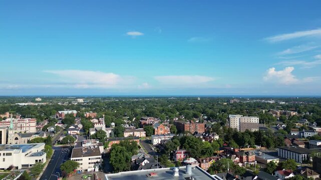 Aerial city moving forward shot over King Street and Church Street north from downtown St. Catharines, Ontario, Canada on a summer morning in July, 2024.