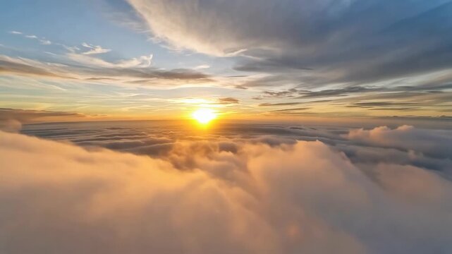 Golden sunrise above rolling clouds as sunlight emerges through mist and layered atmospheric sky during an aerial journey over a vast cloudscape in nature