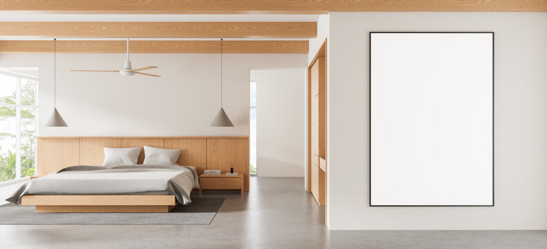 Contemporary bedroom interior design with warm wood paneling, minimalist furnishings, ceiling fan, pendant lights, and blank framed wall art. 3D Rendering