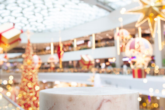Marble pedestal mockup with blurred Christmas mall background