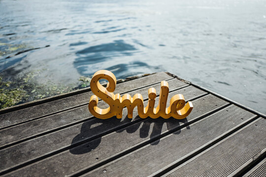 The word 'Smile' on jetty
