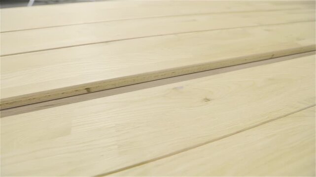 Solid Wood Edge Glued Panels on the floor of the workshop. A stack of Edge-glued solid wood panel in a furniture factory workshop. Solid wood edge glued panels, close-up