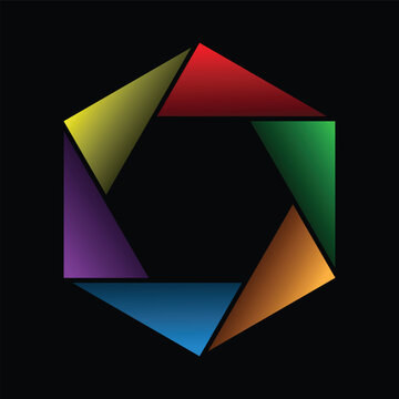 Six colorful triangular shapes in red, yellow, green, blue, purple, and orange form an abstract hexagonal ring with gradient shading and a hollow center on a black background.