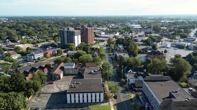 Aerial city moving forward shot over King Street and Church Street towards Geneva from downtown St. Catharines, Ontario, Canada on a summer morning in July, 2024.