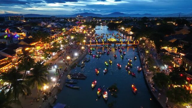 Drone video Hoi An, Vietnam in Quang Nam Province is a popular tourist destination, with colorful lantern boats sailing along the river at night.