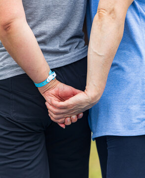 Two people hold hands, showing support and connection