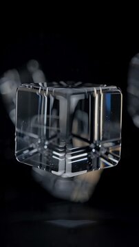 Macro cinematic scene of transparent glass cubes floating slowly in a minimalist dark environment, subtle reflections and refractions changing as the cubes rotate, controlled camera orbit
