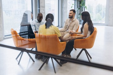 Diverse people sharing feelings in group therapy session, receiving support, empathy, and mental...