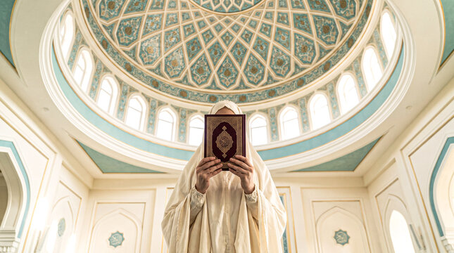 Muslim woman holding quran inside mosque for ramadan prayer and