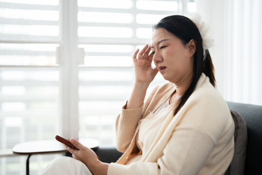 Woman hand on forehead, feeling unwell,dizzy and headache at home.