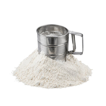 Shiny silver metal flour sifter is partially submerged in a large pile of white flour on a clean white background