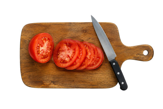 Fresh red tomato slices and a sharp kitchen knife rest on a rustic wooden cutting board, isolated on white