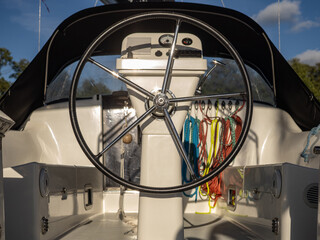 Boat Helm And Steering Wheel In Yacht Cockpit With Colorful Ropes And Navigation Instruments © Michał Kiełbicki