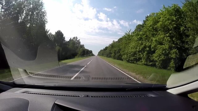 POV Driving Through Green Forest on Rural Road in Belarus